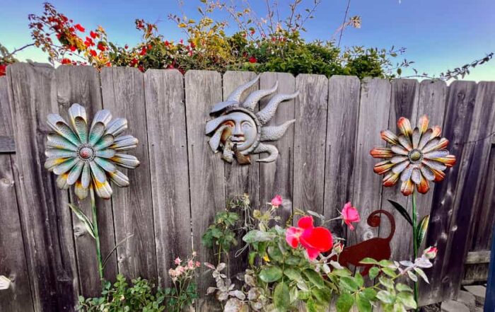 my favorite garden with metal flowers and sun, a few flowers in bloom